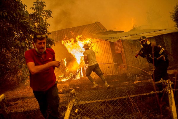 A burning house in Pefki, Greece. Forest fires have raged as the region suffers a heat wave..jpg